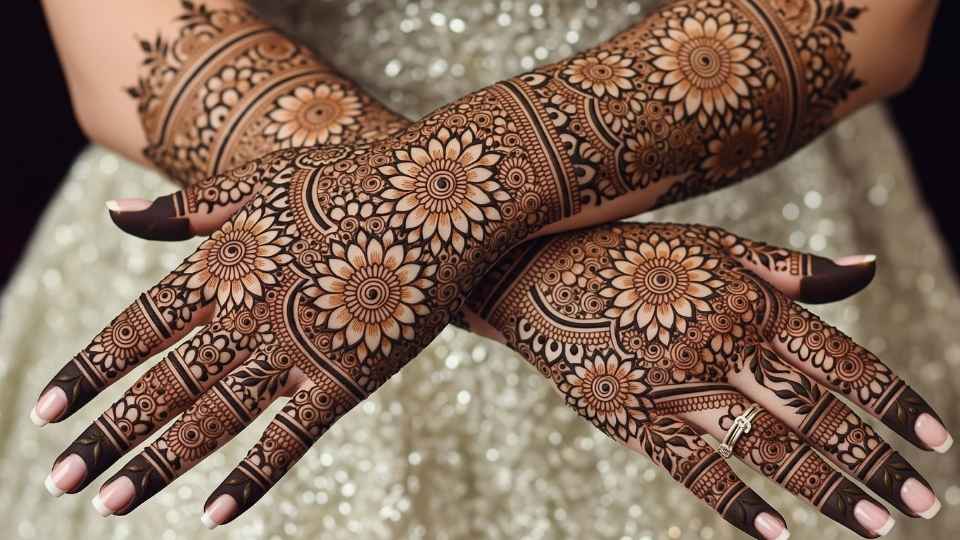 A stunning full-hand bridal mehndi design featuring dense traditional patterns and multiple chrysanthemum blooms.